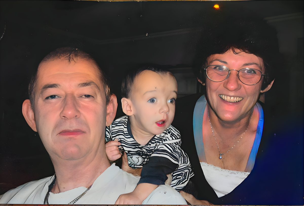 A family photograph after restoration &mdash; sharp faces, recovered colour